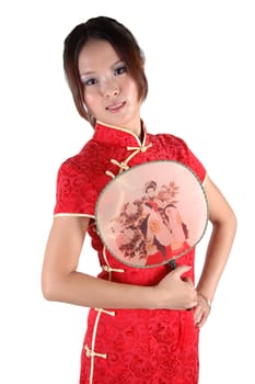 Chinese model in traditional dress called QiPao, holding fan. Asian cute girl, young model with friendly and happy face expression.