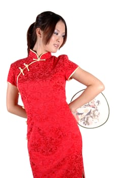 Chinese model in traditional dress called QiPao, holding fan. Asian cute girl, young model with friendly and happy face expression.