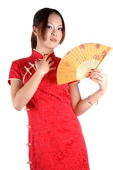 Chinese model in traditional dress called QiPao, holding fan. Asian cute girl, young model with friendly and happy face expression.