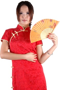 Chinese model in traditional dress called QiPao, holding fan. Asian cute girl, young model with friendly and happy face expression.