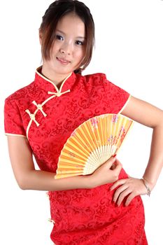 Chinese model in traditional dress called QiPao, holding fan. Asian cute girl, young model with friendly and happy face expression.