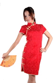 Chinese model in traditional dress called QiPao, holding fan. Asian cute girl, young model with friendly and happy face expression.