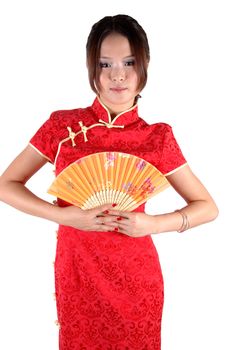 Chinese model in traditional dress called QiPao, holding fan. Asian cute girl, young model with friendly and happy face expression.