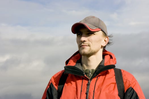 Photo of the man in sportswear against the cloudy sky