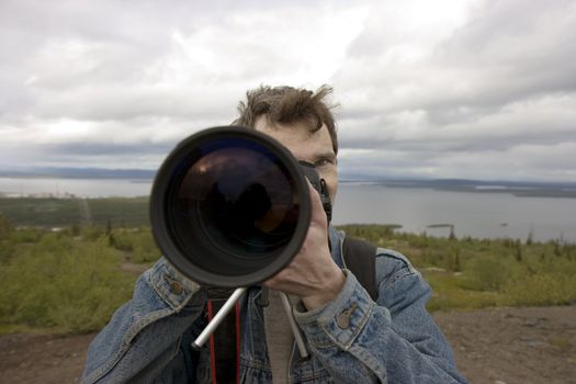 The image of the photographer against the nature