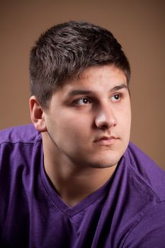 A serious young man that is thinking about something very deeply.