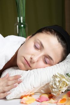 relaxed, young woman lying after or during a massage

