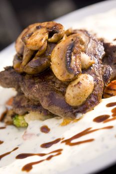 Juicy steak with mushrooms and sauce