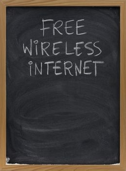 free wireless internet advertisement handwritten with white chalk on blackboard, copy space below, eraser smudges