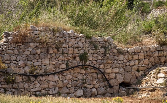 An old and neglected historic Roman wall on the island of Malta