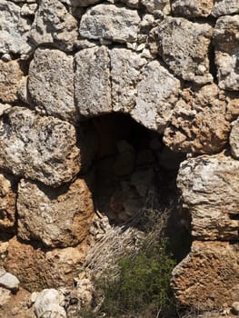 An old and neglected historic Roman wall and door on the island of Malta