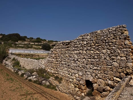 An old and neglected historic Roman wall on the island of Malta