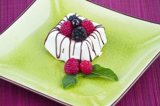 Black and White chocolate with blackberries on green plate