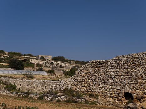 An old and neglected historic Roman wall on the island of Malta