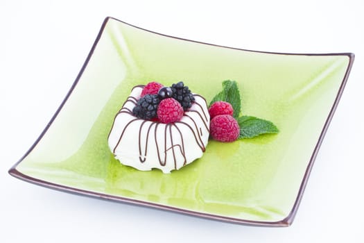 Black and White chocolate with blackberries on green plate