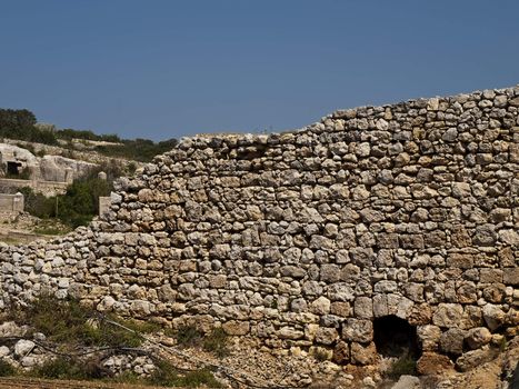 An old and neglected historic Roman wall on the island of Malta