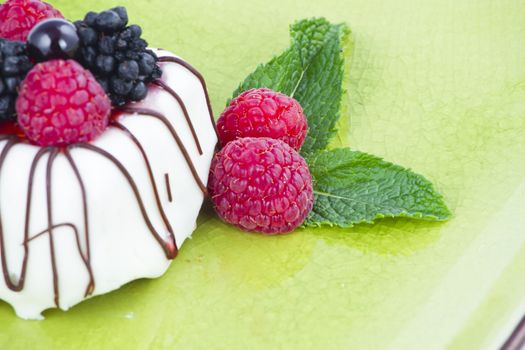 Black and White chocolate with blackberries on green plate