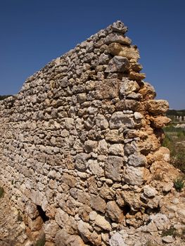 An old and neglected historic Roman wall on the island of Malta