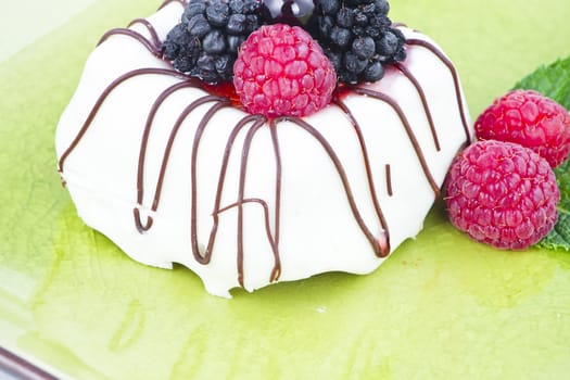 Black and White chocolate with blackberries on green plate