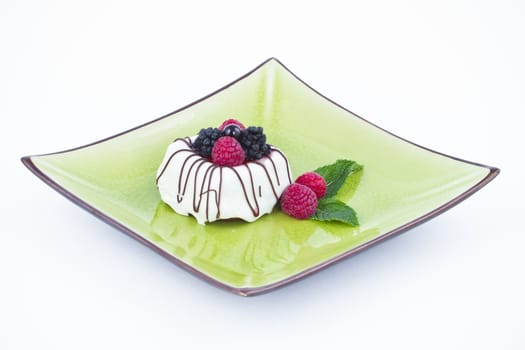 Black and White chocolate with blackberries on green plate