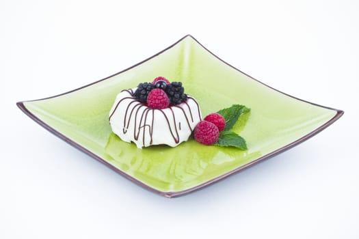 Black and White chocolate with blackberries on green plate