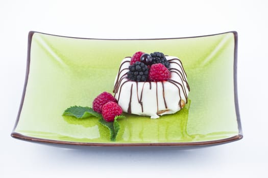 Black and White chocolate with blackberries on green plate