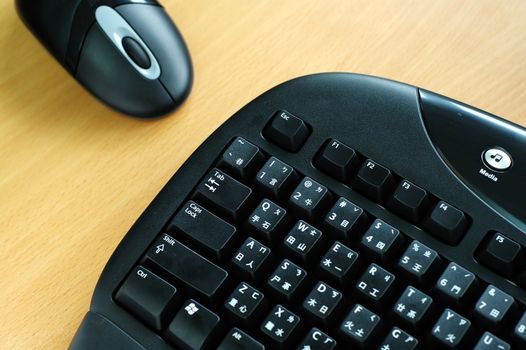 Black wireless keyboard and mouse on desk