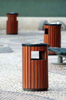 Three wooden litter bins in public area
