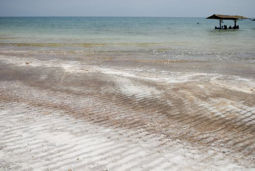 Coastline of dead Sea with lots of salt on banks