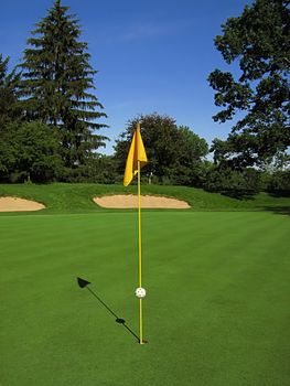 A photograph of a golf course in the afternoon.