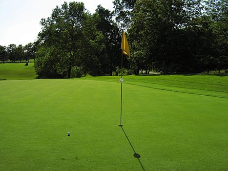 A photograph of a golf course in the afternoon.