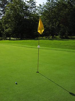 A photograph of a golf course in the afternoon.