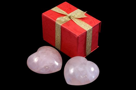 Two pink stoned hearts with a gift box