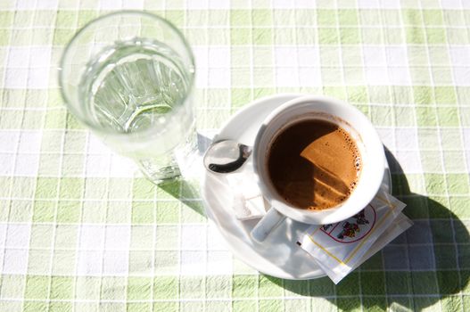 Cup of coffee and water on the table