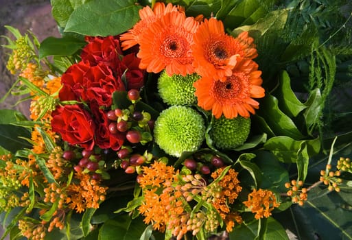 Bouquet of flowers in red, orange and green colors  