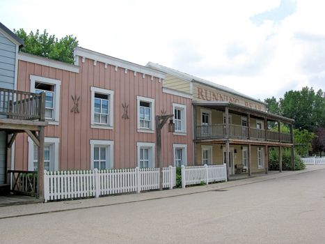 A deserted cowboy town, with wooden buildings.