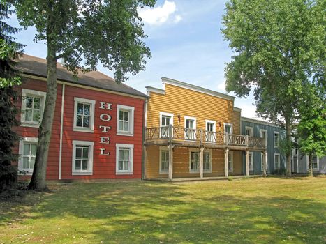 A deserted cowboy town, with wooden buildings.