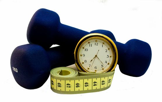 Two dumbbells, measuring tape and clock isolated on white  