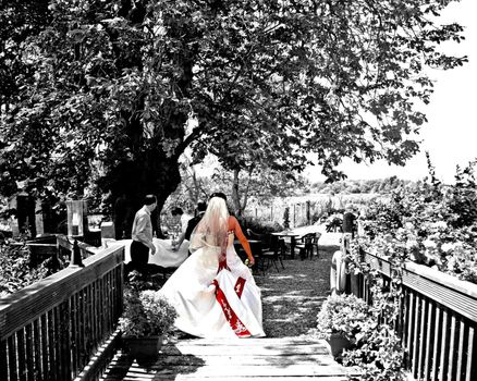 A Bride walking to her Reception over a bridge.