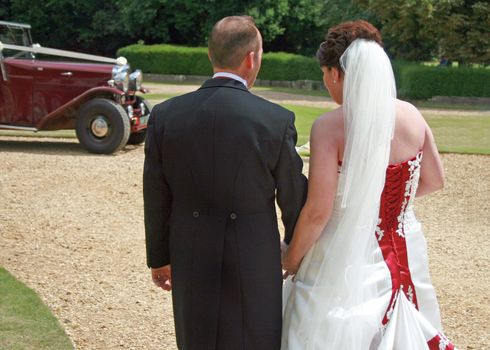 Back of Bride and Groom Walking to Wedding Car