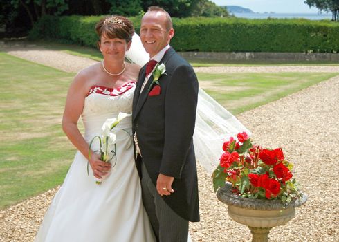 Bride and Groom in the countryside with Roses