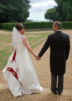 Back of Bride and Groom Holding Hands after the Wedding.