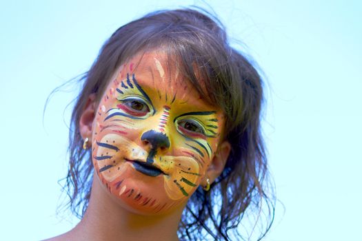 Little girl portrait with face paint of lion