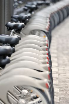 Wheels of bicycles on the walkway. Photo with tilt-shift lens