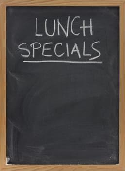 lunch specials title handwritten with white chalk on blackboard, copy space below, restaurant advertisement