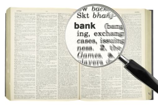A magnifying glass on the word BANK on a dictionary.