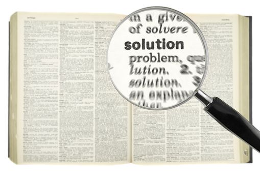 A magnifying glass on the word SOLUTION on a dictionary.