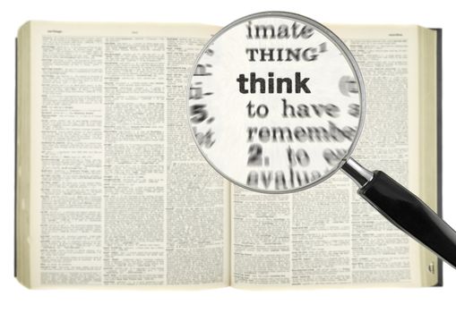 A magnifying glass on the word THINK on a dictionary.