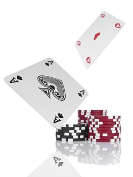 Two aces flying over piles of gambling chips. Isolated on white.