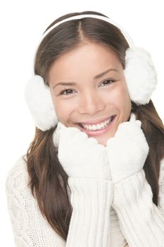 Winter beauty woman smiling playful, cute and happy looking at camera. Portrait of mixed Asian / Caucasian young woman isolated on white background